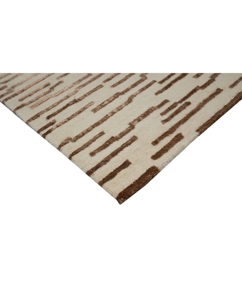 D A S H luxury modern rug by Cherom featuring a minimalist design with warm brown accents on a beige background.