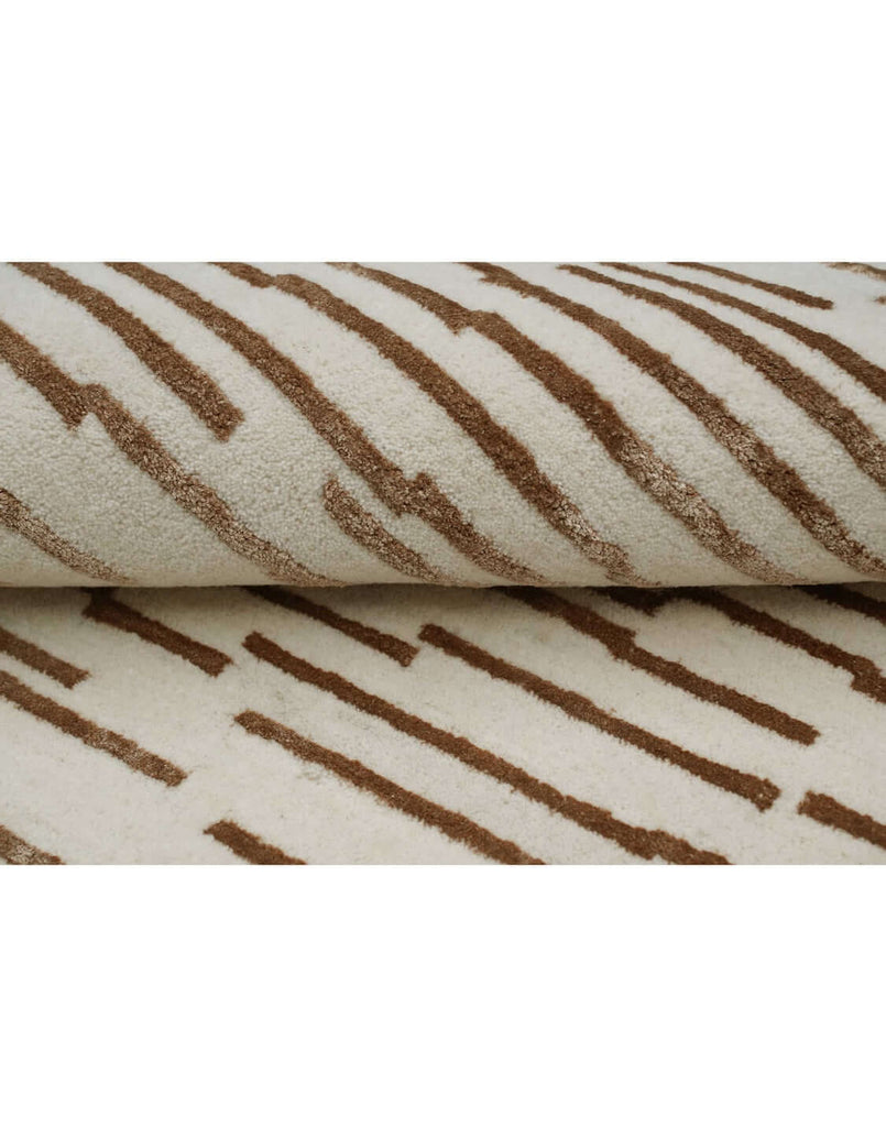 D A S H luxury modern rug by Cherom featuring warm brown lines on a soft beige background.