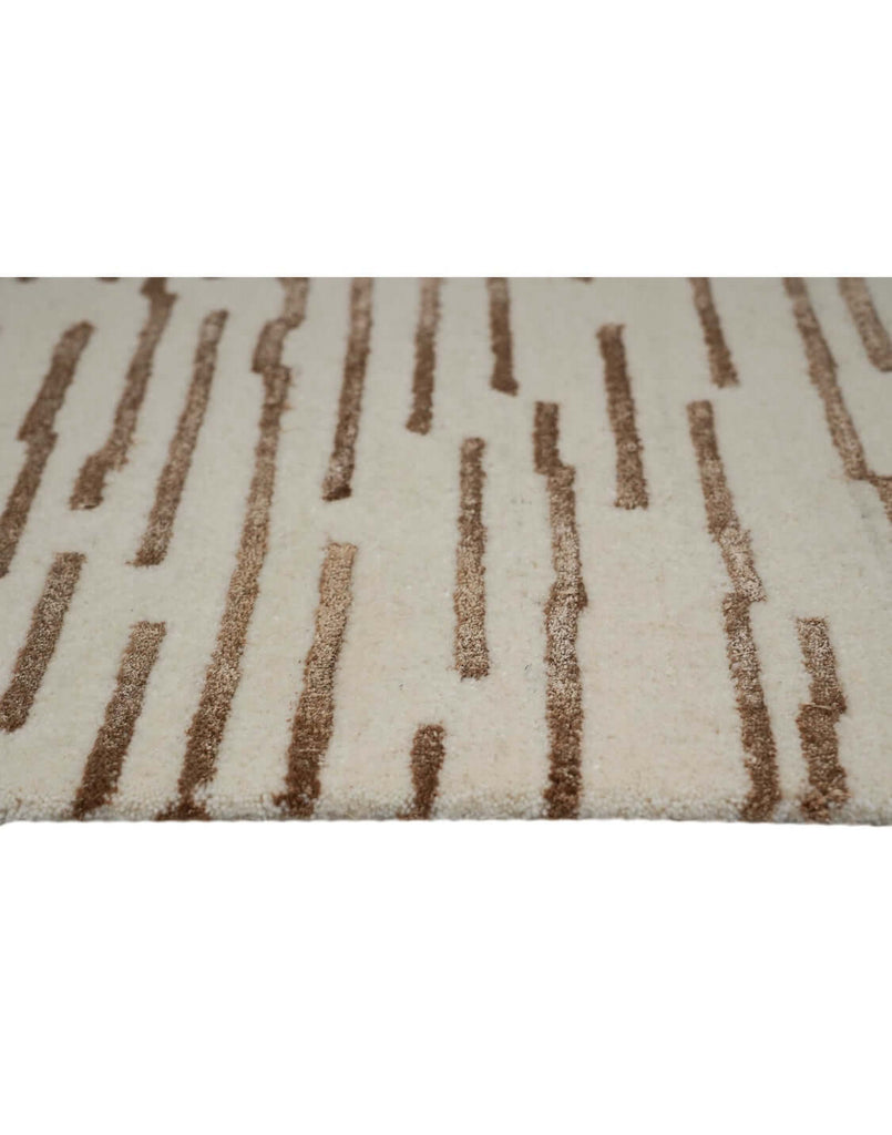 D A S H luxury modern rug by Cherom, featuring warm brown accents on a soft beige background.