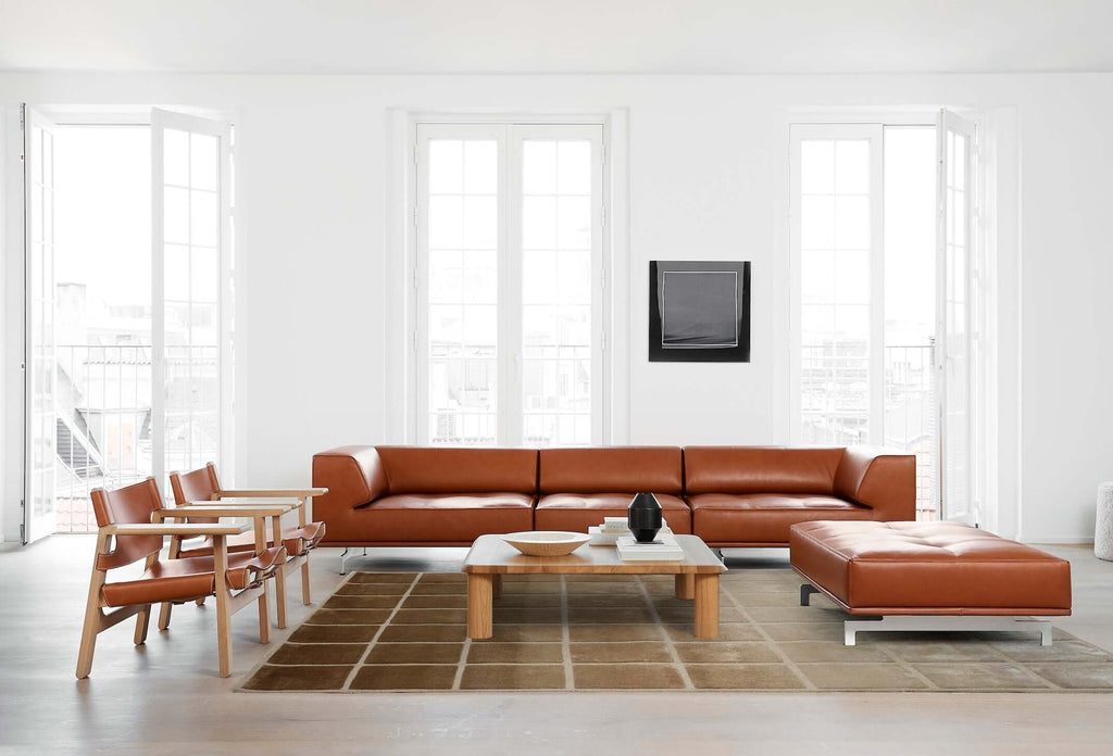 F A D E luxury modern rug by Cherom in a contemporary living room setting with leather furniture.