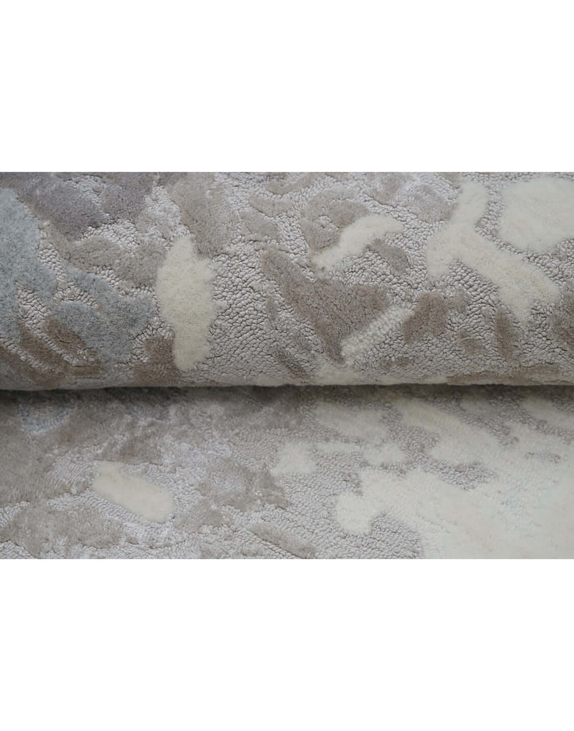 F R O S T luxury modern rug by Cherom, featuring a serene mix of charcoal, silver-grey, taupe, and ivory shades.