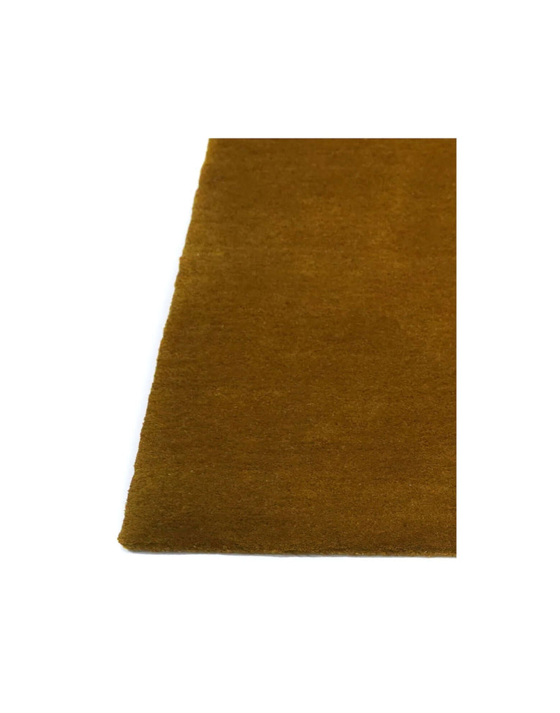 I C O N - O C H R E rug detail showing high-quality New Zealand wool and rich ochre color.