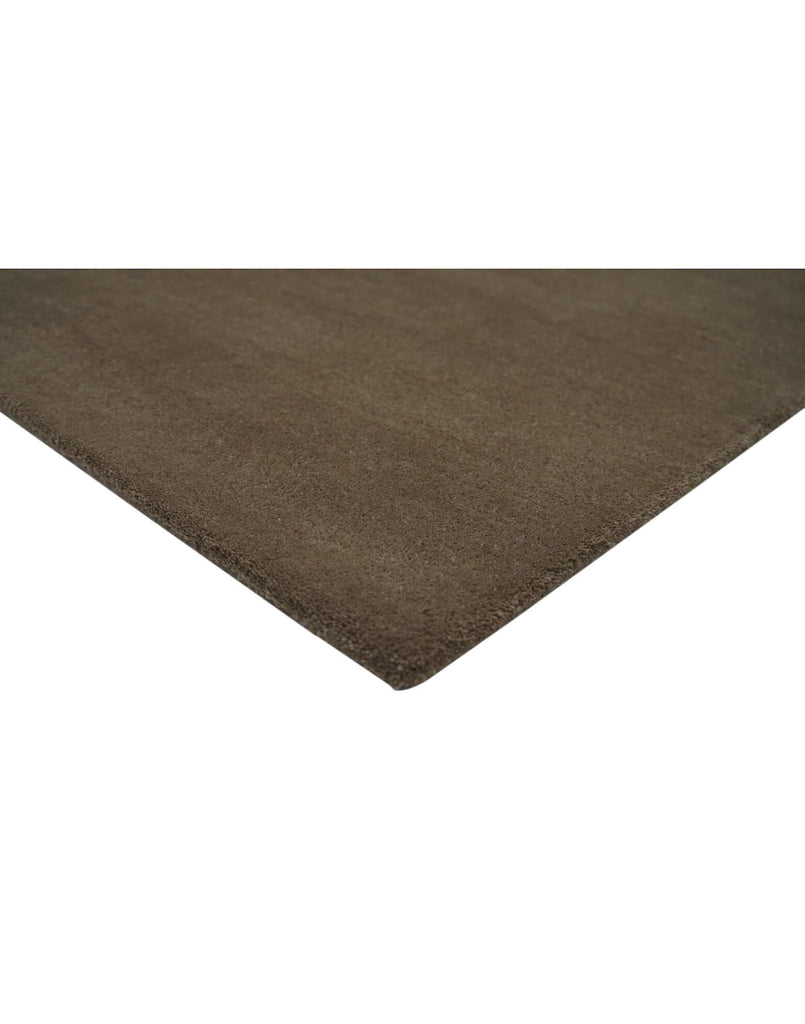 I C O N - T R U F F L E rug corner detail in rich brown, showcasing high density tufted craftsmanship and quality New Zealand wool.