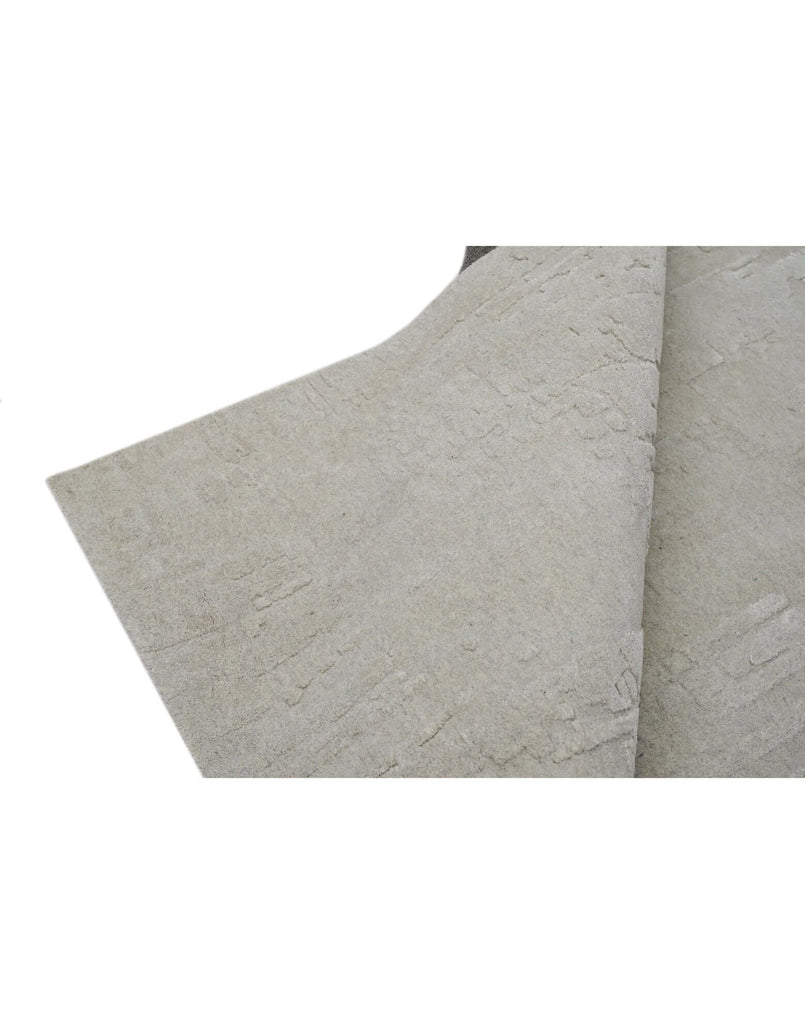 S C U L P T E D - U R B A N A luxury modern rug by Cherom in soft grey with carved texture.