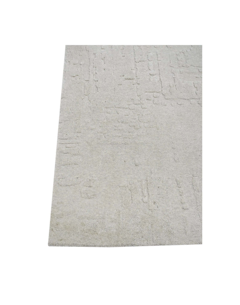 S C U L P T E D - U R B A N A luxury modern rug by Cherom, featuring a soft grey tone and carved texture.