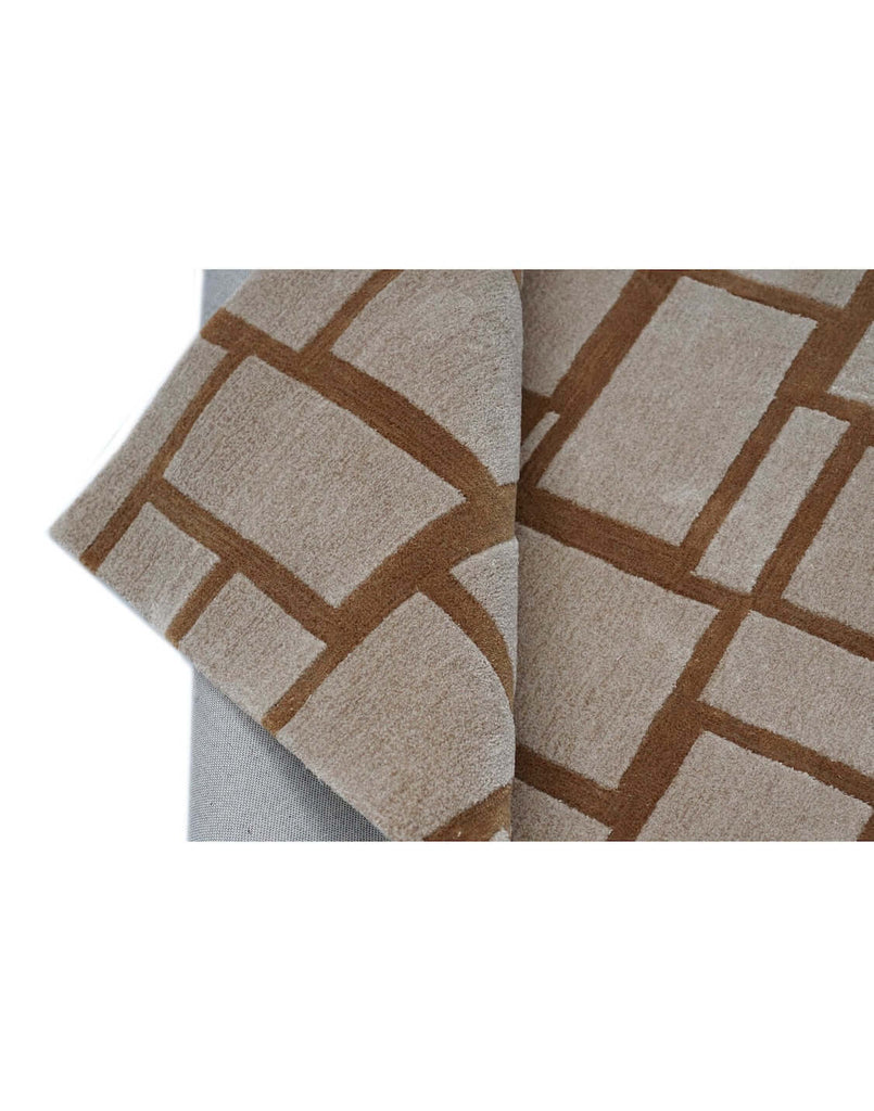 S T O N E W O R K luxury modern rug by Cherom, featuring a structured grid pattern in rust and beige.